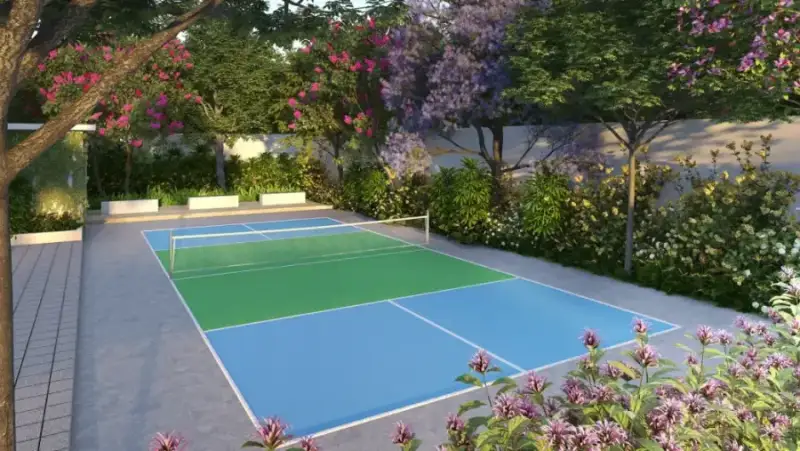 Pickleball court framed by blossoms at Suraksha Whispering Waves, Begur